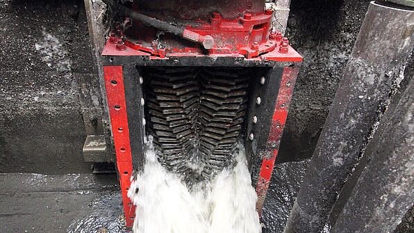 Industrial red water shredder processing wastewater flow.